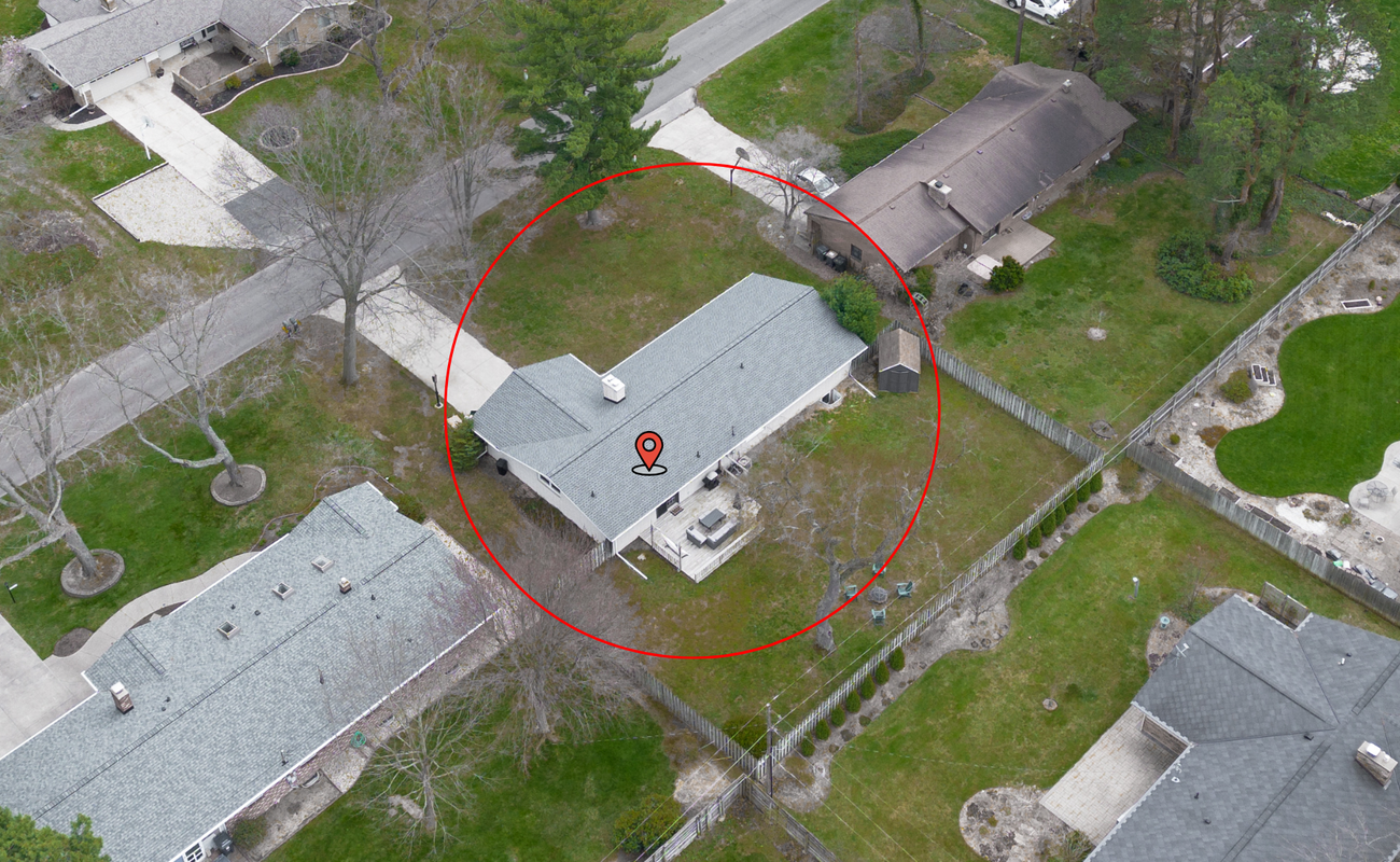 Aerial view of the property with a private yard, cozy patio, and room to relax—right where the pin drops!