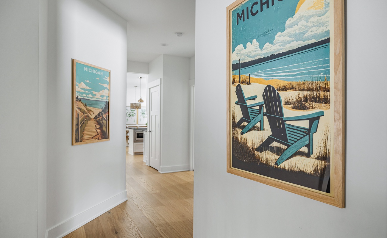 Welcoming hallway with charming Michigan-themed art—your cozy getaway starts here!