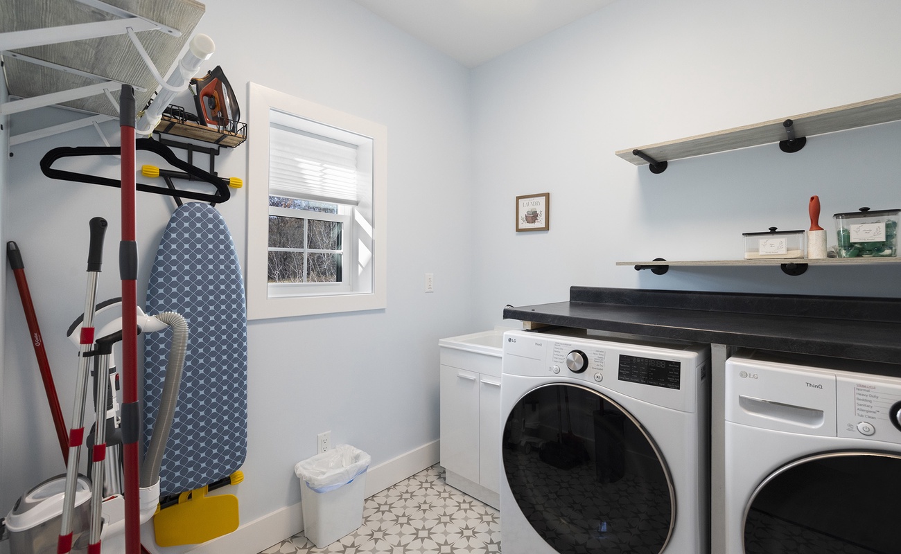 Main-level laundry room designed to keep stays effortless and organized.