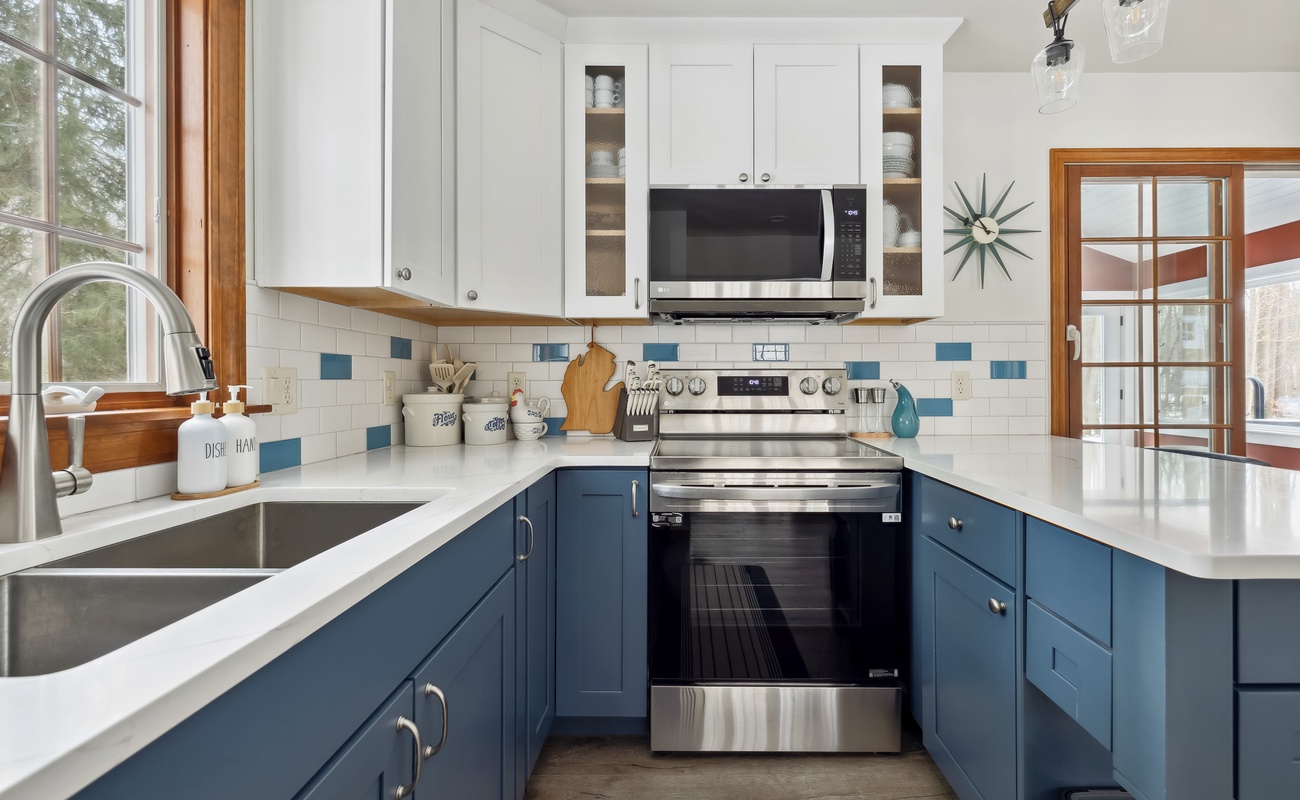 Blue cabinets, sleek appliances, and just enough counter space to pretend I’m on a cooking show.