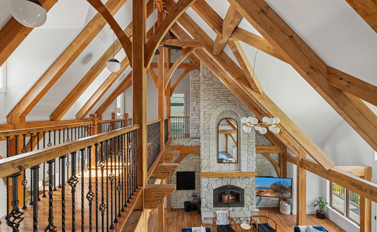 Cozy up under the beams and by the fire—this living room is everything.