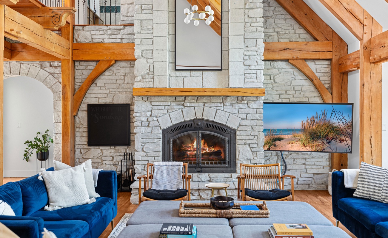 Stone, wood, and a crackling fire—this living room is peak relaxation.