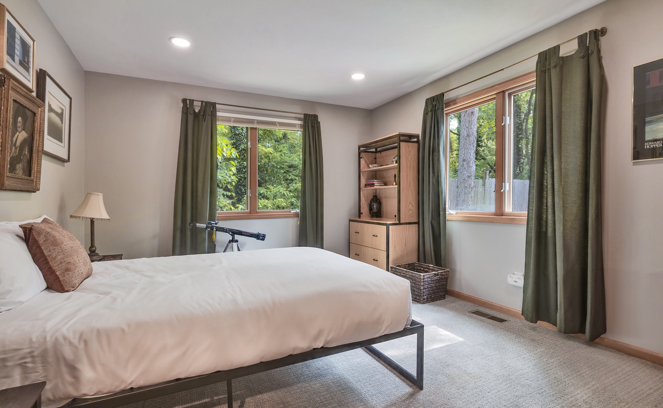 Serenity meets simplicity in this forest-view room.