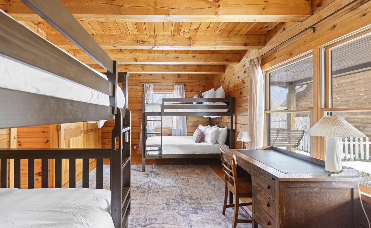 Bedroom 2 is on the main level with 2 full bunkbeds and dedicated workspace.