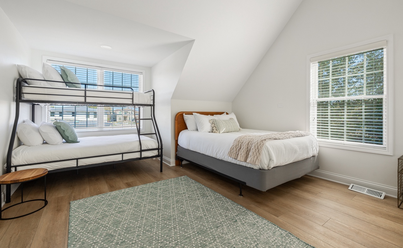 Bedroom 4 is on the upper level & has a queen-size bed, single-over-full bunkbed and twin bunkbed.