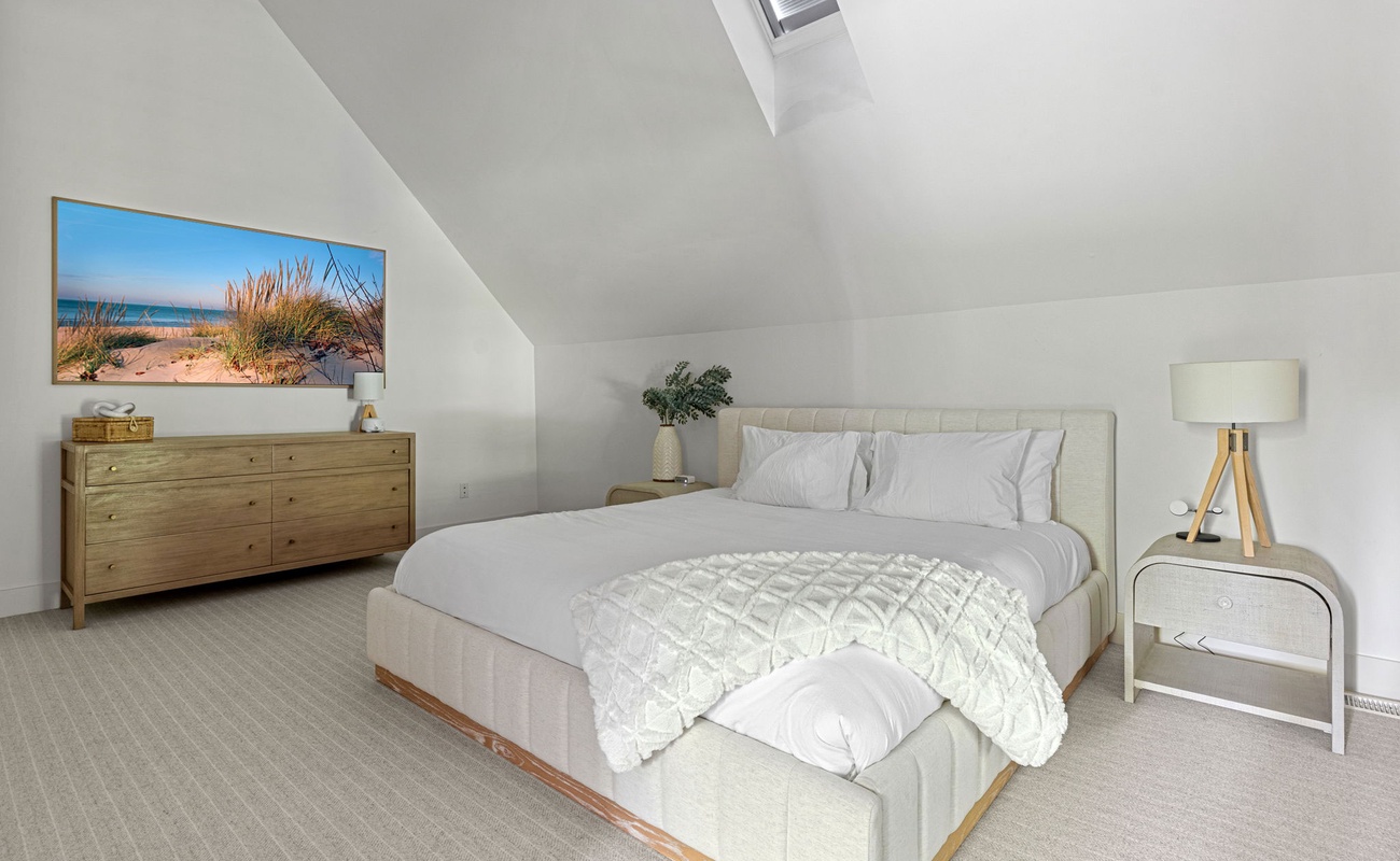 Primary bedroom is on the upper level & has a king-size bed.