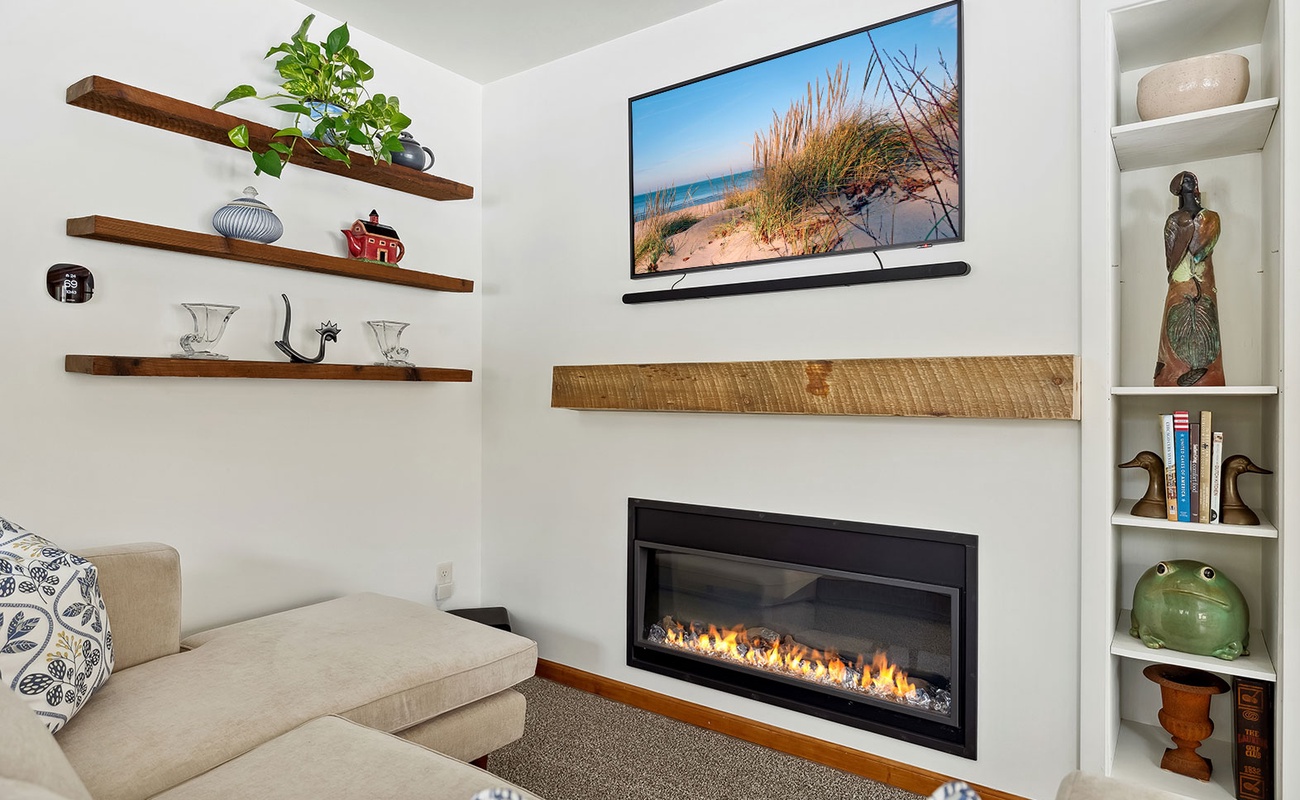 Fireplace? Check. Snug couch? Check. Randomly adorable frog on the shelf? Also, check.