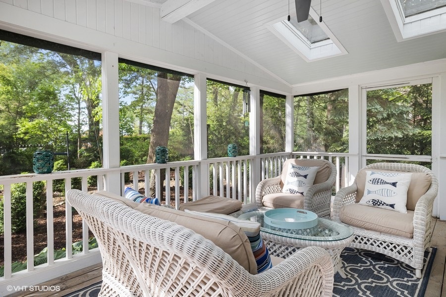 Relaxing in style on our screened porch, complete with elegant wicker furniture and a soothing ceiling fan.