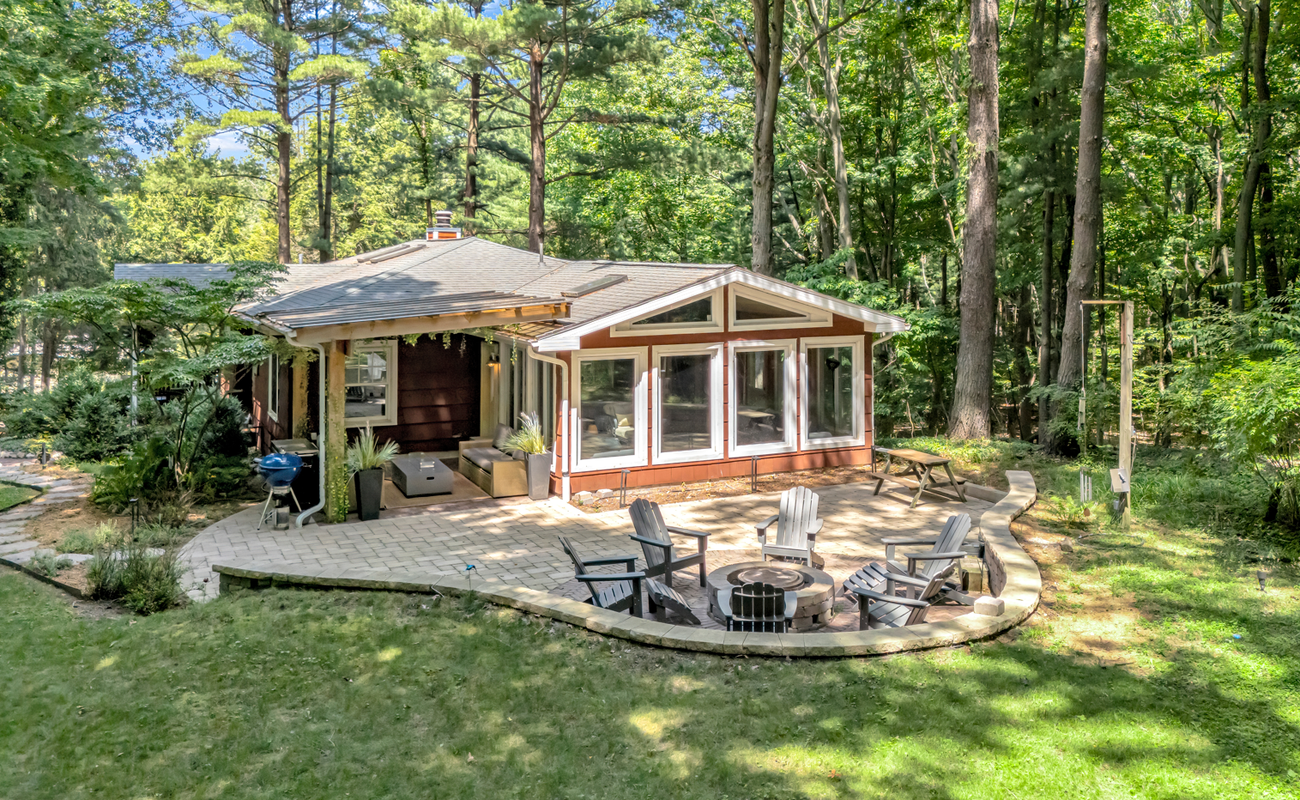 A private woodland escape with fire pit and outdoor lounge.