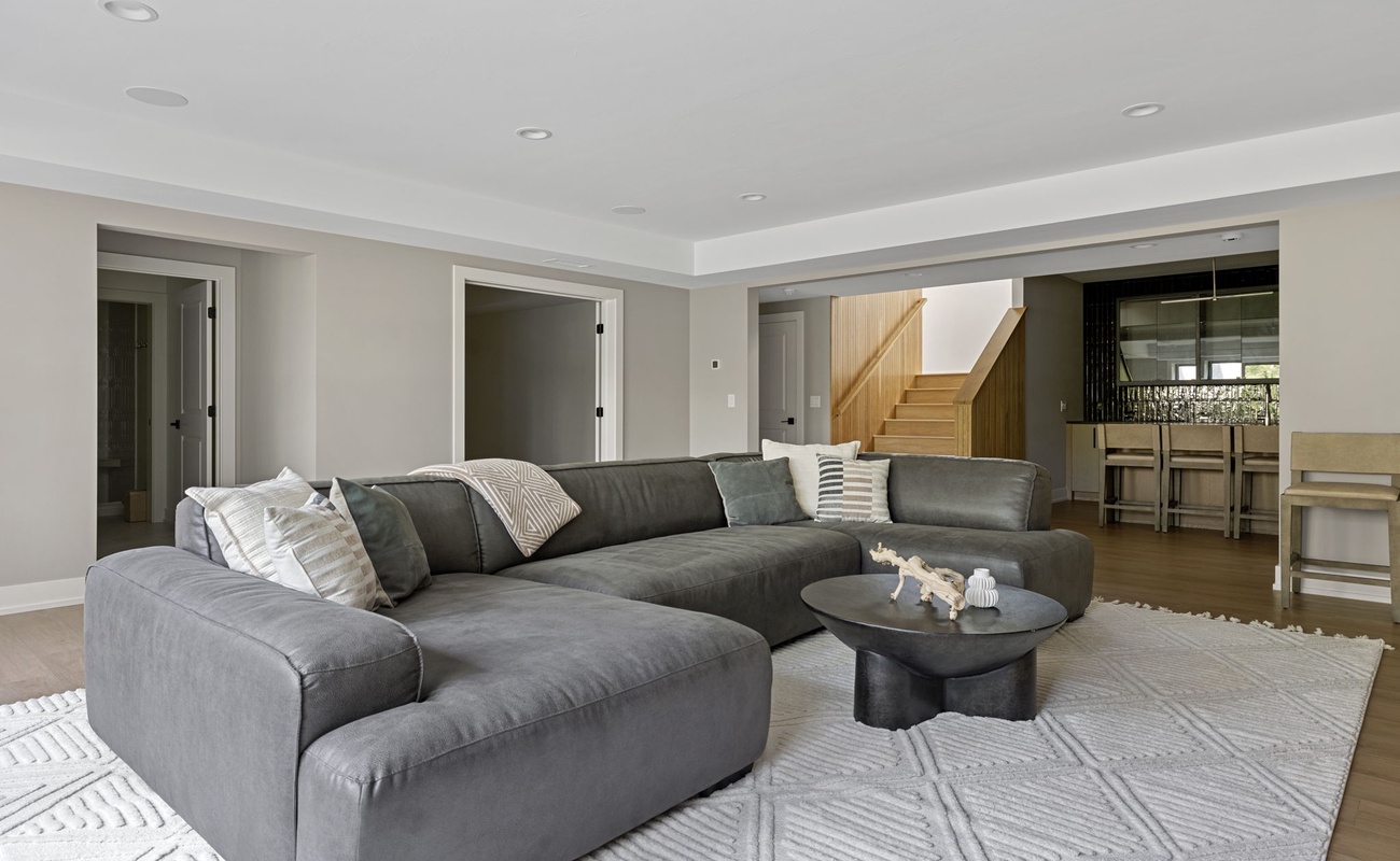 Loving the minimalist look of my living room featuring a gray couch and a white rug.