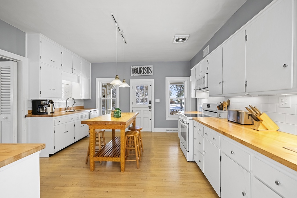 Sunlit prep space and warm wood counters define The Farmhouse's kitchen.
