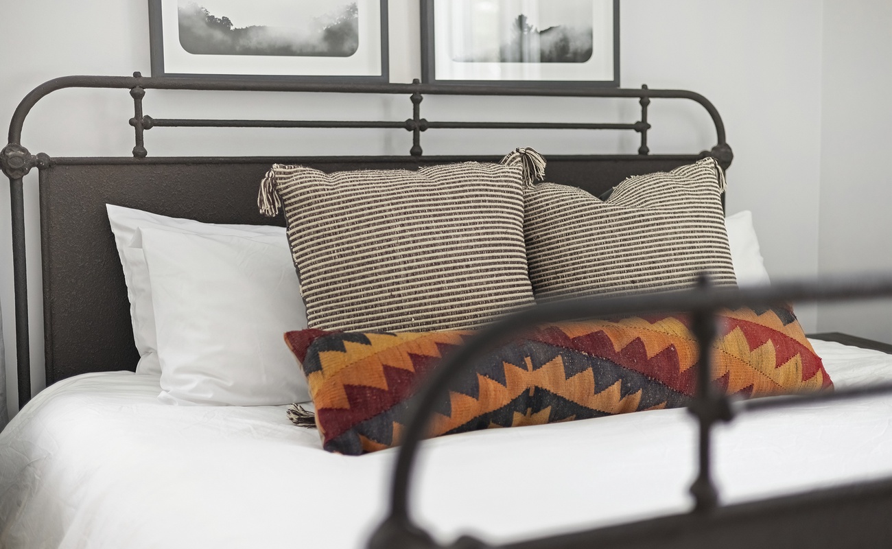 A warm, welcoming bedroom with artful touches throughout.