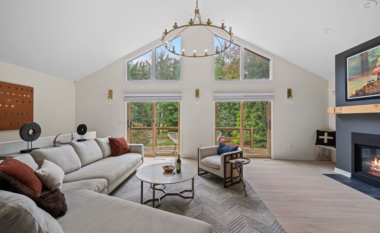 The living room looks out onto a large wooden deck, which affords beautiful sunsets.