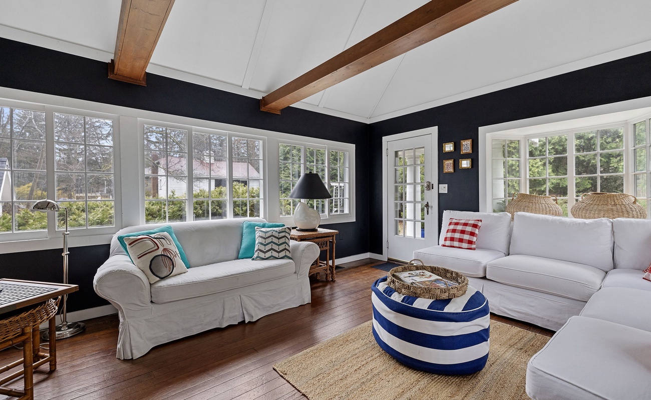 Wraparound French windows feed light + beauty into this popular gathering spot.