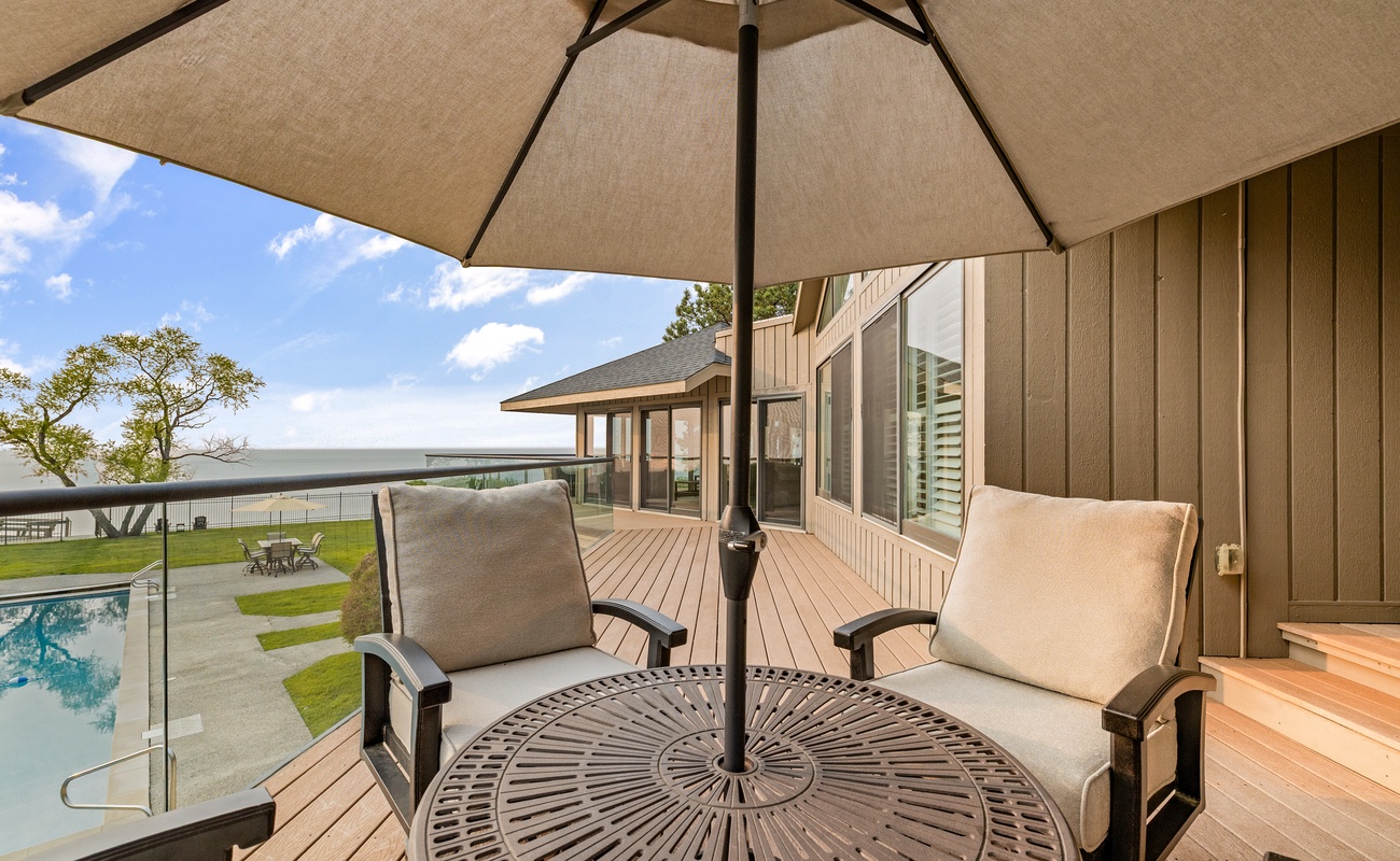 Relax under the umbrella with a panoramic lakefront view.