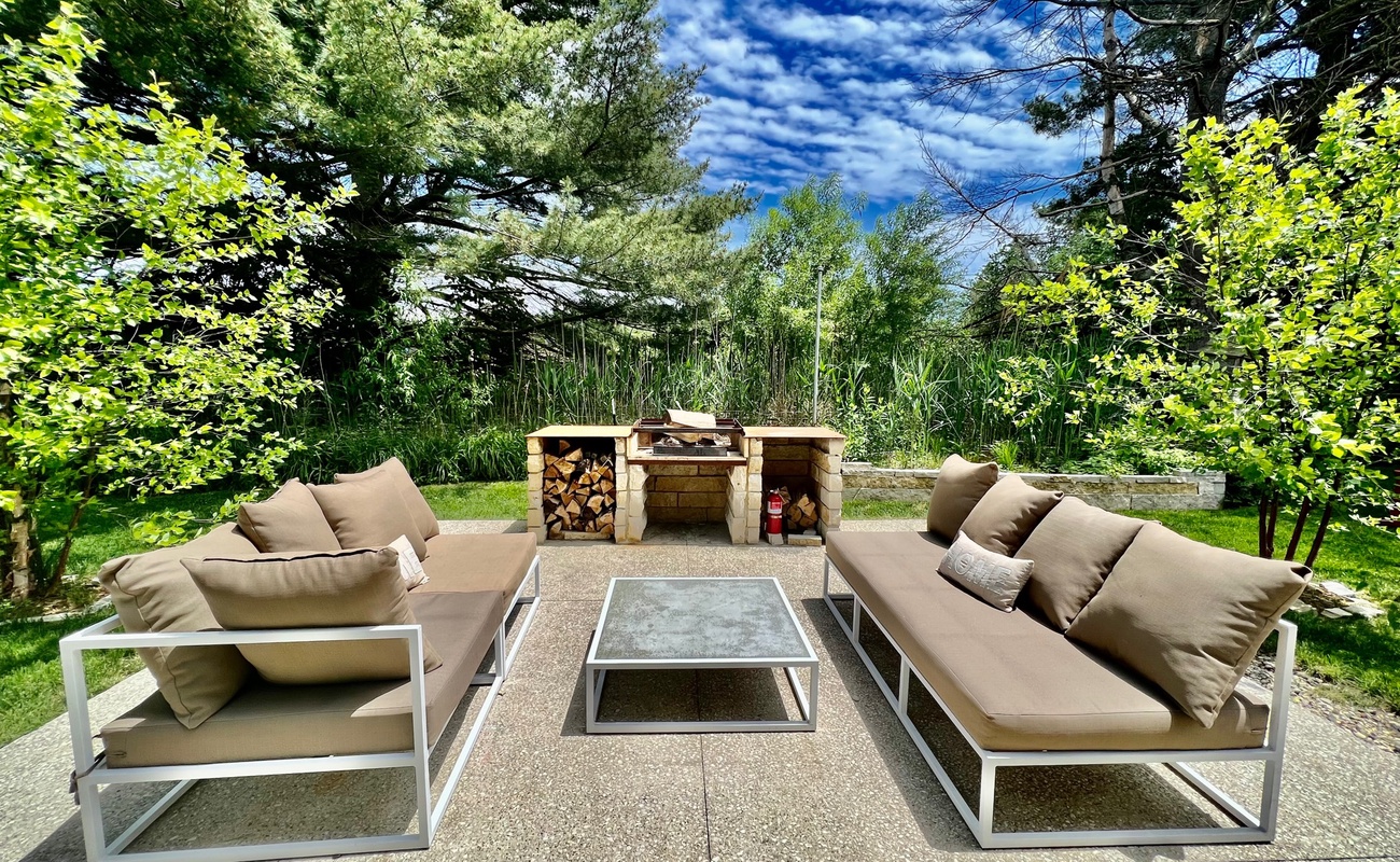 Outdoor living at The White Owl is elevated by fireside seating area.