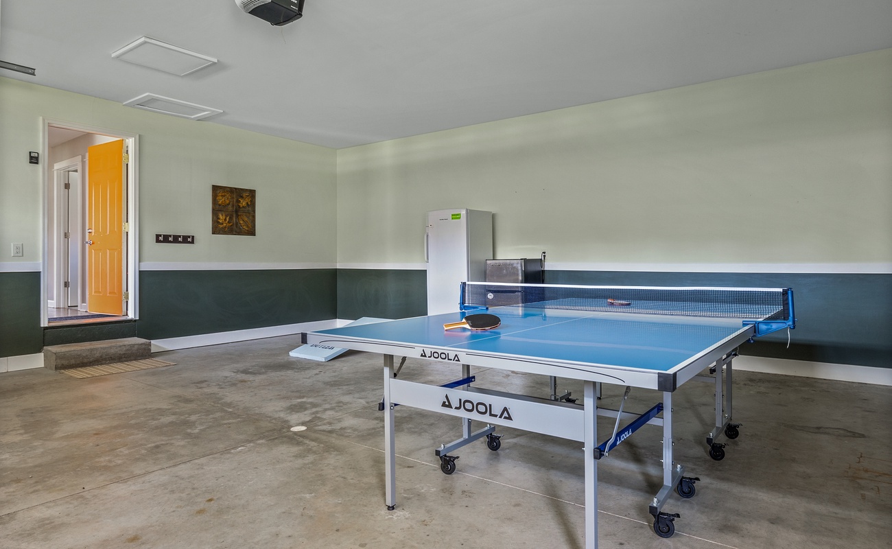 Bright and upscale game space featuring a Joola ping pong table.