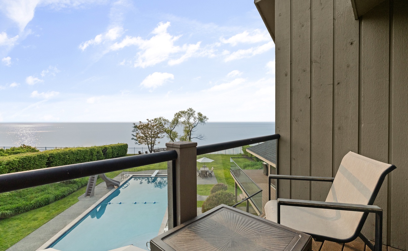 Balcony bliss with pool views and endless lake horizon.