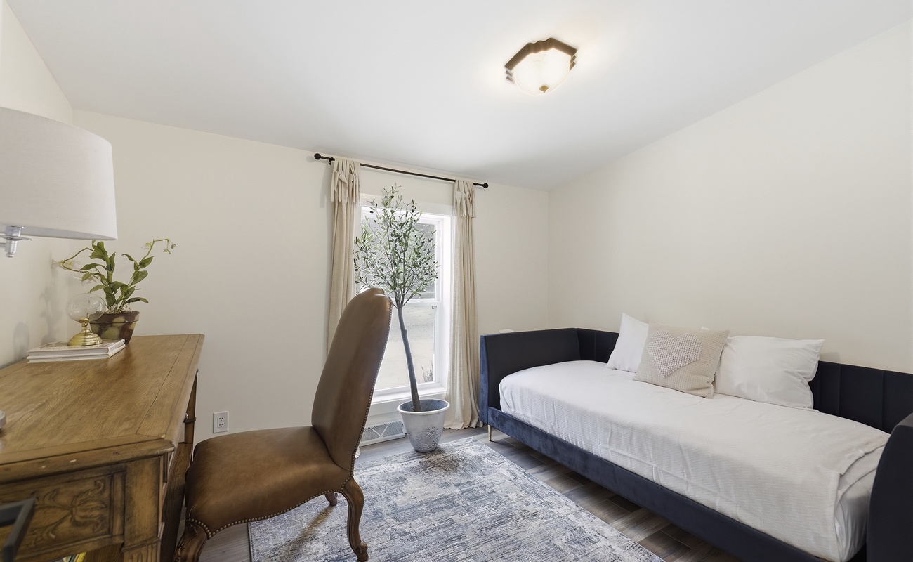 Bedroom 5 offers a quiet dedicated desk and a comfortable daybed.