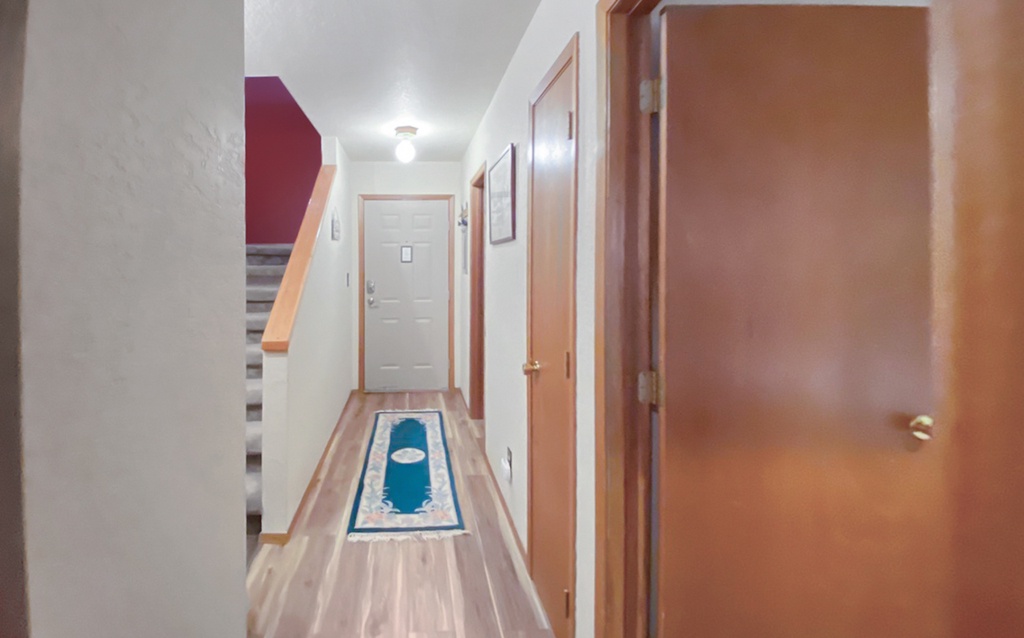 A clean and minimalist entryway with a pop of color.