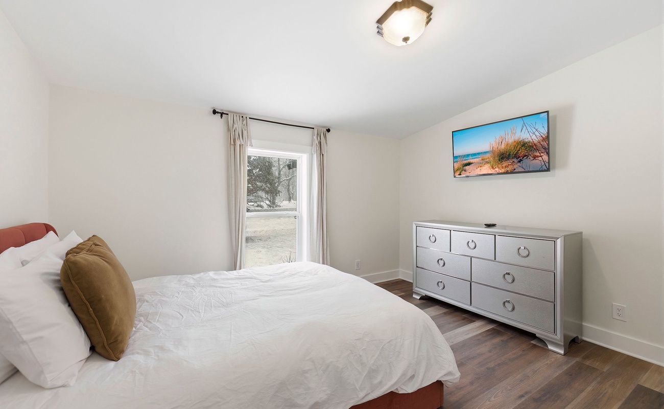 A bright guest bedroom with space to unpack and settle in.