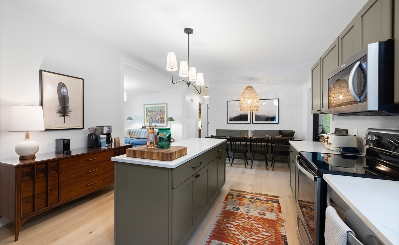 The kitchen opens to dining, creating space for effortless gathering.