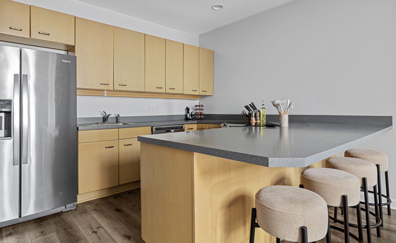 Mixing modern and rustic vibes in my kitchen with sleek stainless steel appliances and cozy wooden floors.