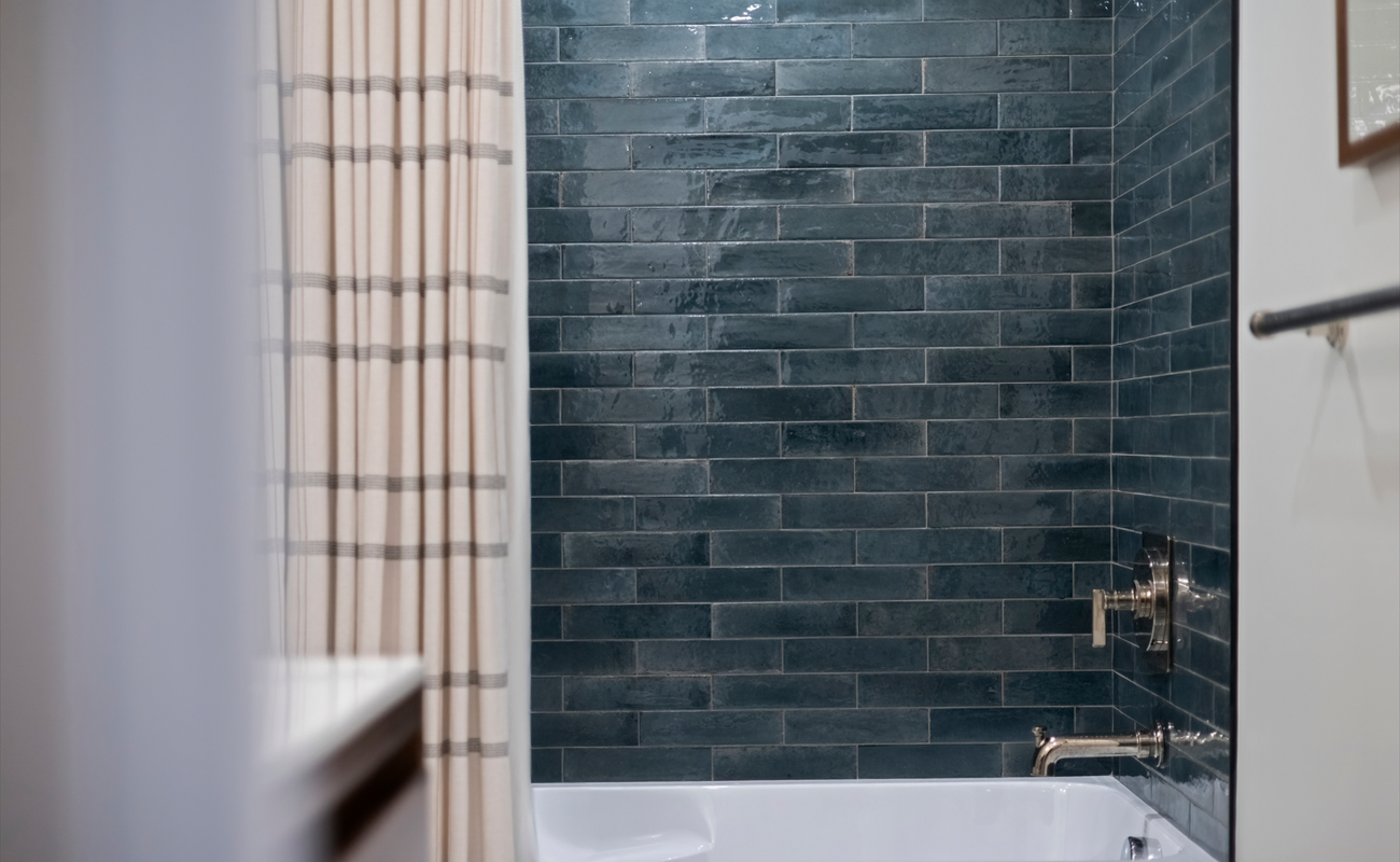 Rich aquamarine tones create a calm, modern bath retreat.