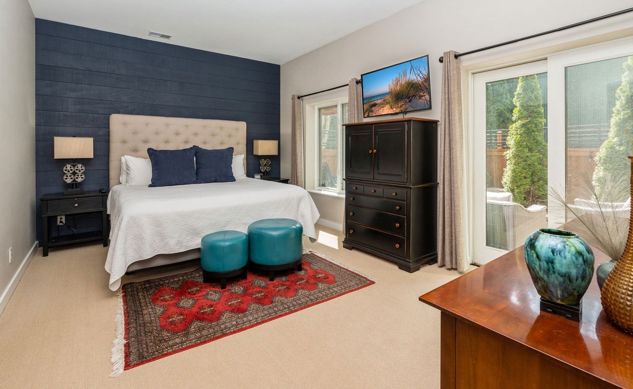 Primary bedroom has a king-size bed with outdoor access.