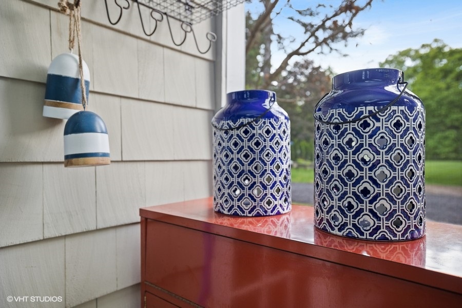 A pop of color with the blue vases on the red table adds a touch of elegance to the room.