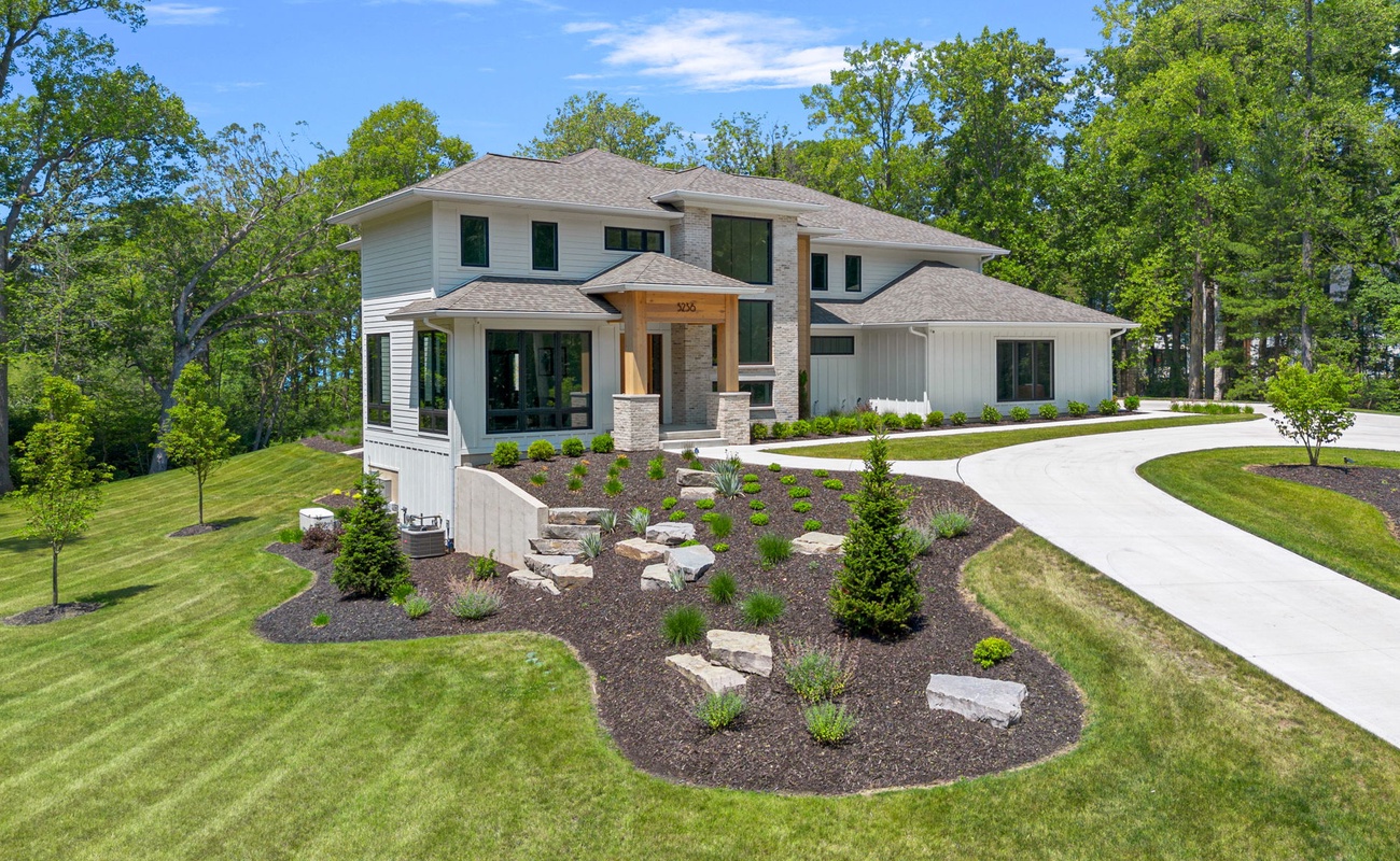 Nestled amidst lush landscaping and towering trees, this large abode is the epitome of tranquility.