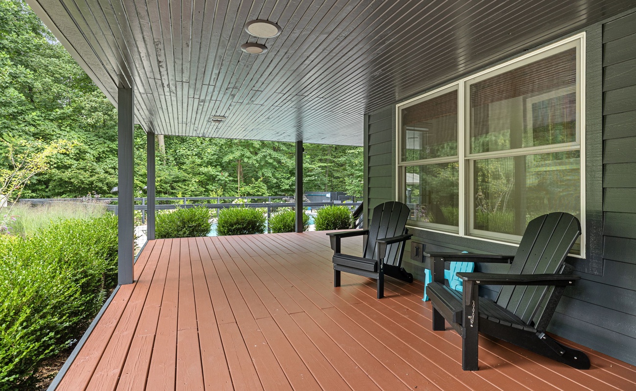 Picturesque wooden porch with serene garden surroundings.