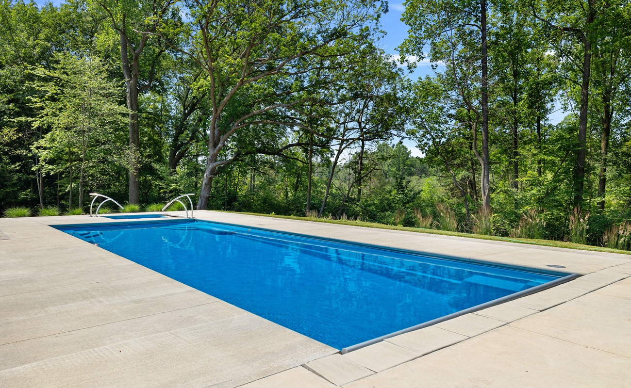 Relaxing by the pool surrounded by nature's beauty.