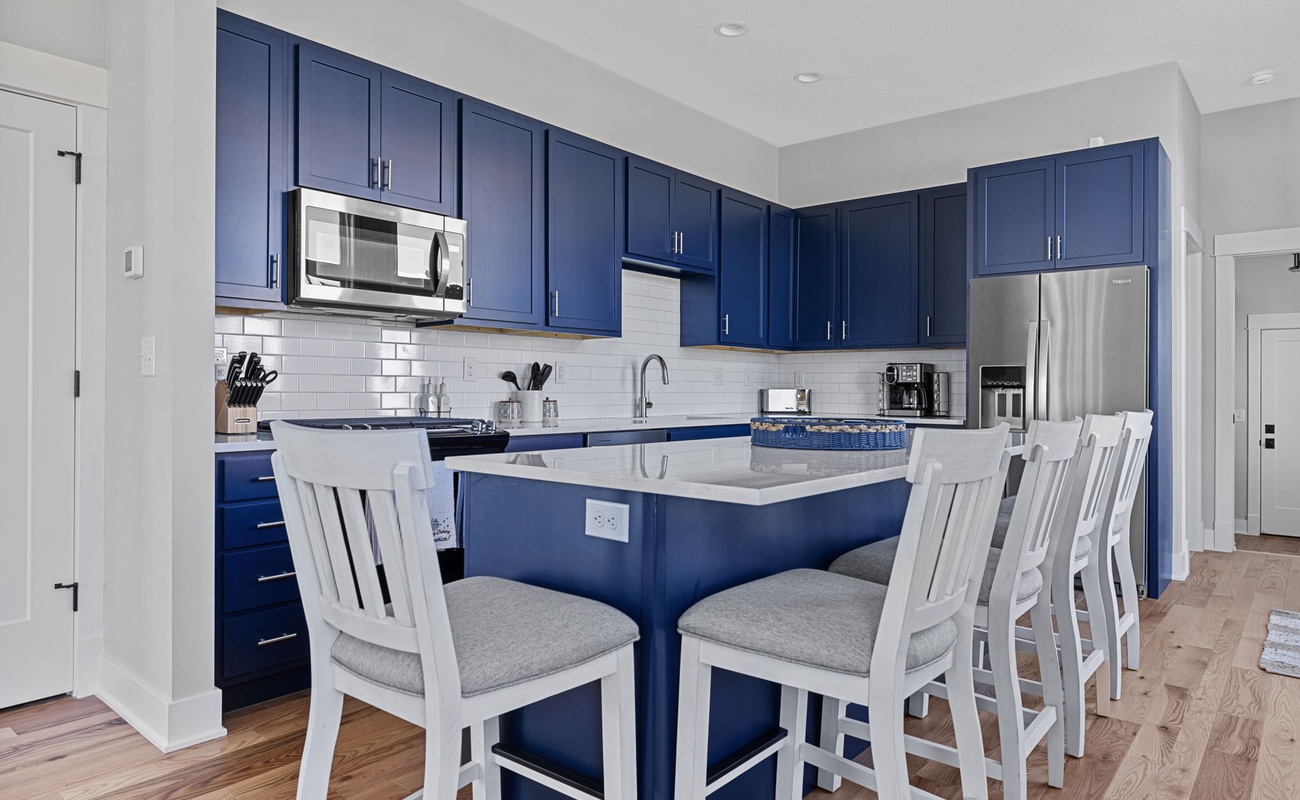 With seating for 5, the kitchen's center island is a popular gathering spot.