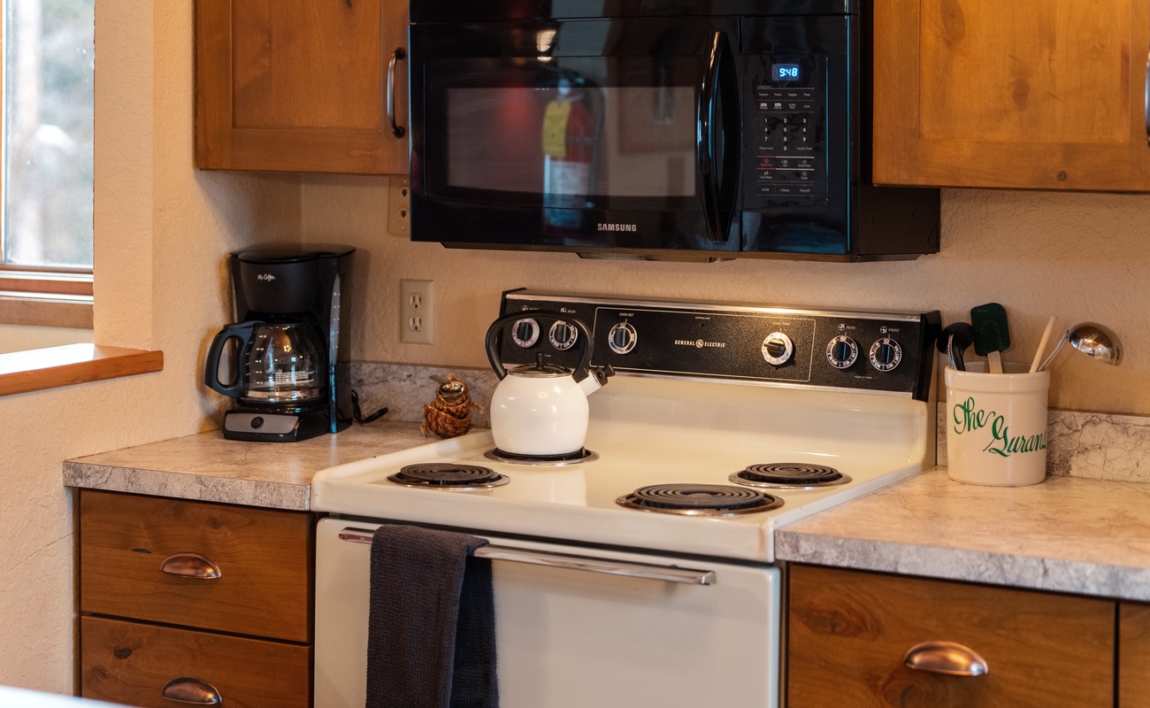 Cooking made easy! This kitchen is all about convenience with a microwave and refrigerator ready to whip up delicious meals in no time