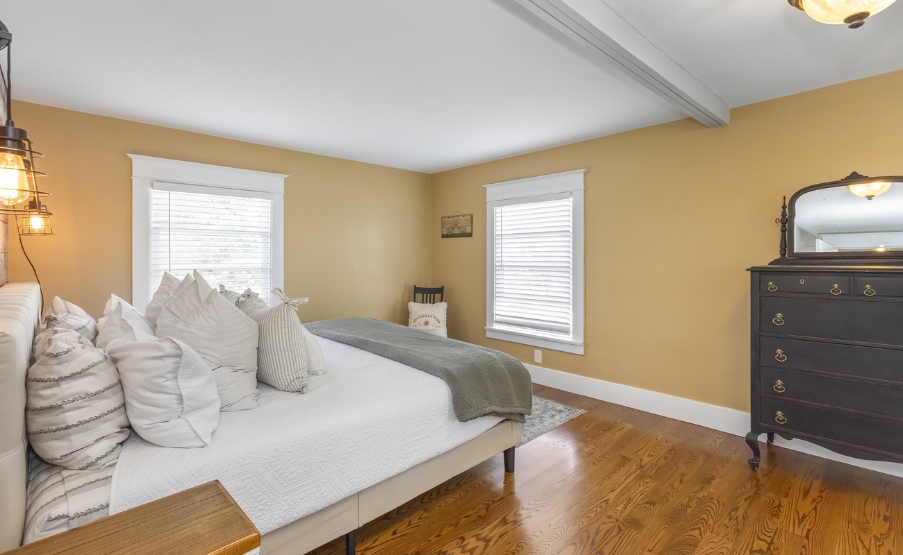 A serene bedroom retreat with rich wood and golden glow.