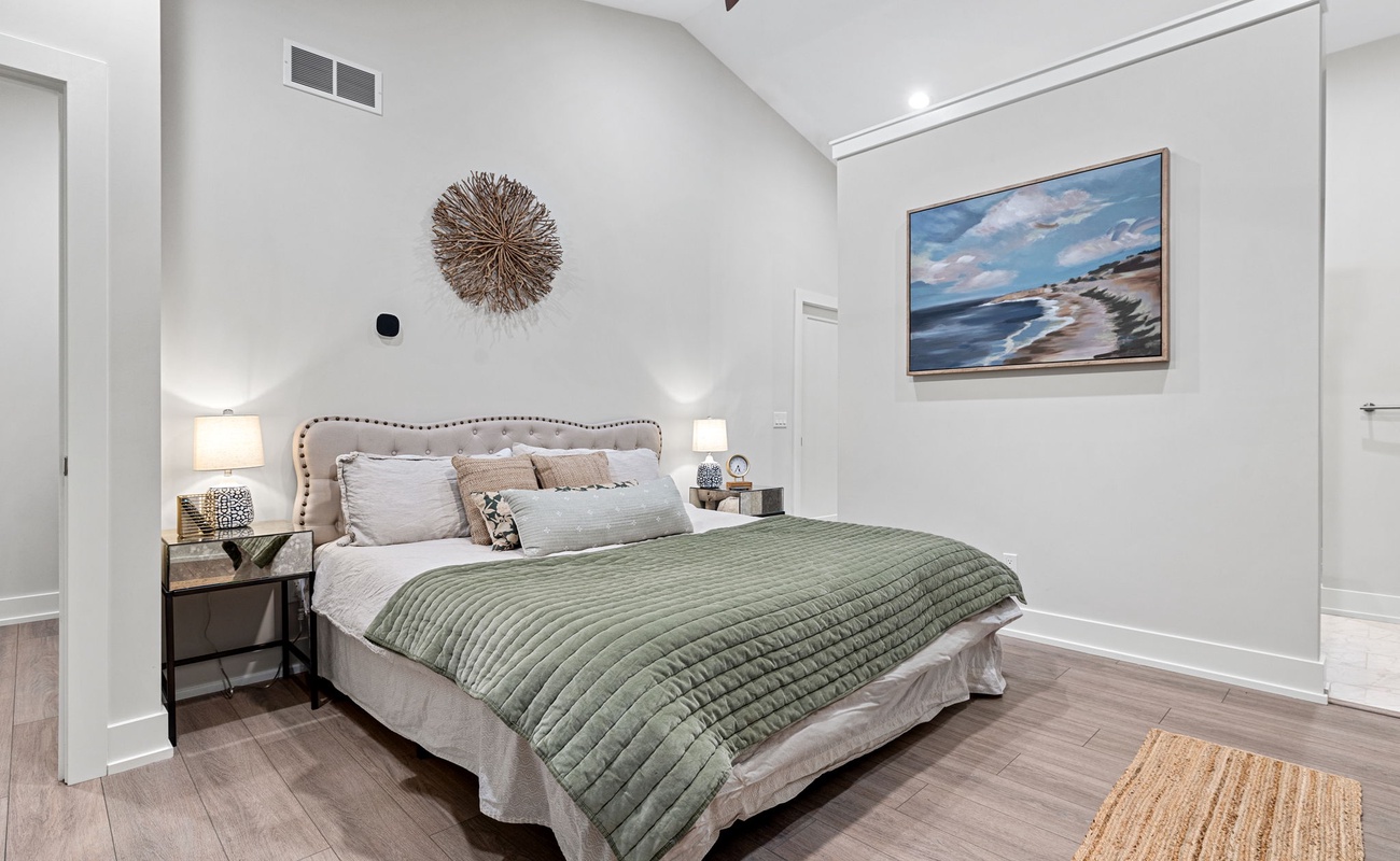 Primary bedroom is on the top level & has a king-size bed.