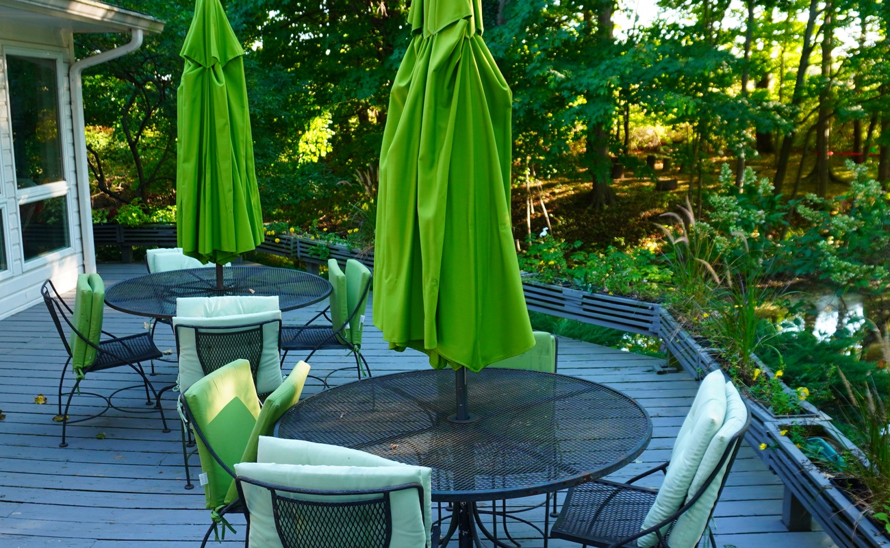 Dine outdoors at The Farmhouse with beautiful wooded scenery.