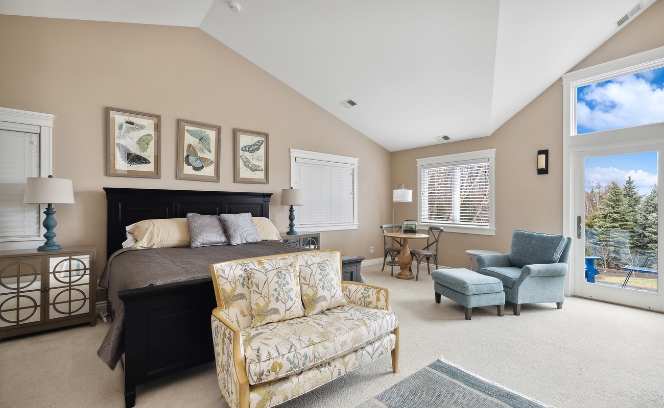 Primary bedroom is on the upper level & has a king-size bed.