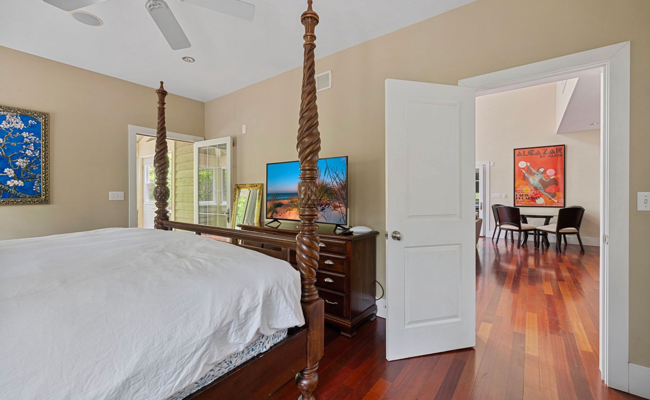 Exquisite wood-carved 4-poster bed. Flat-screen TV. Easy outdoor access. Check.