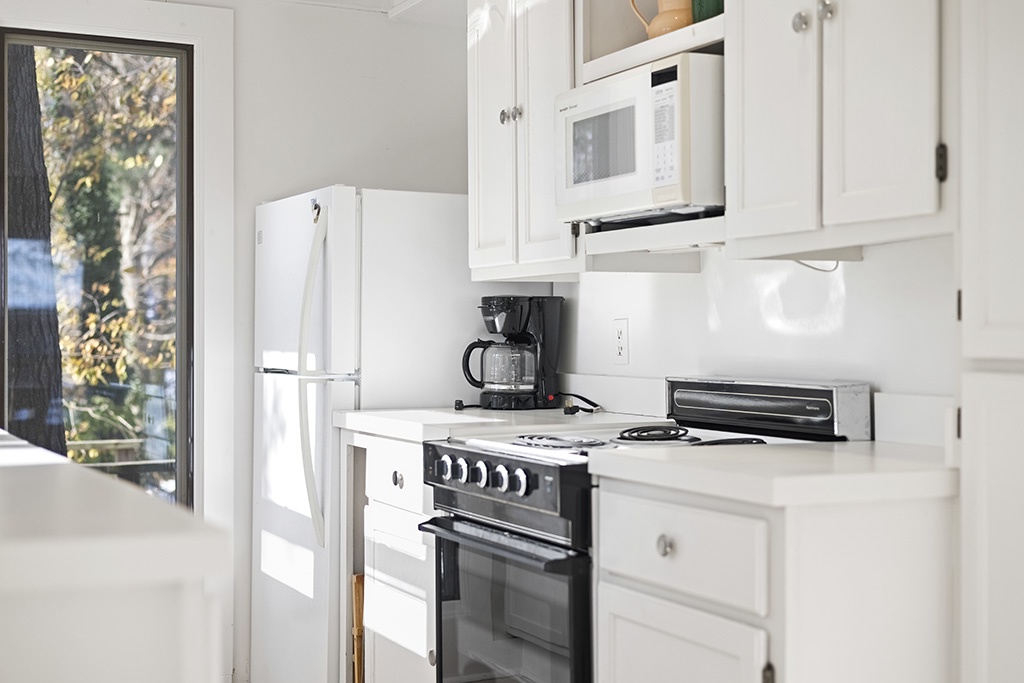 Morning light brightens The Cottage’s simple, well-equipped kitchen.