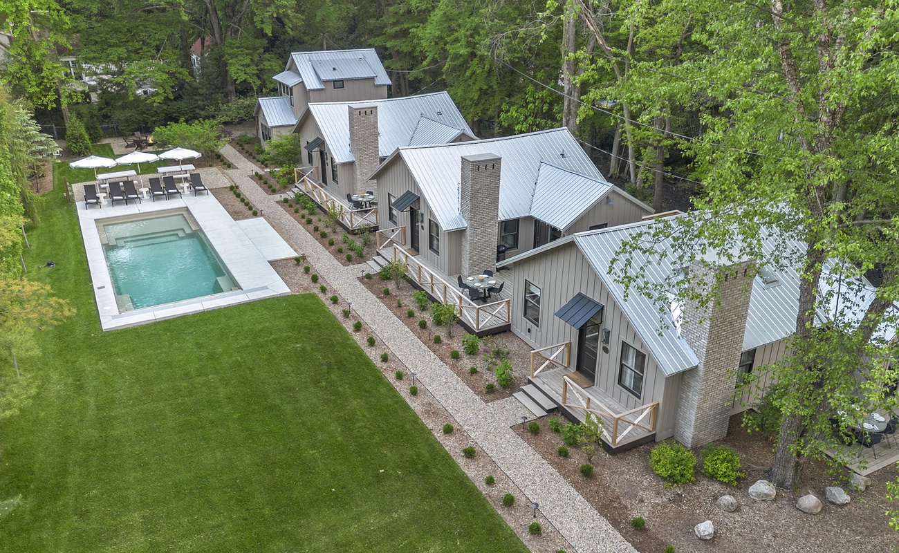 Embrace the tranquility of this beautiful residence featuring a refreshing pool and a vibrant lawn.