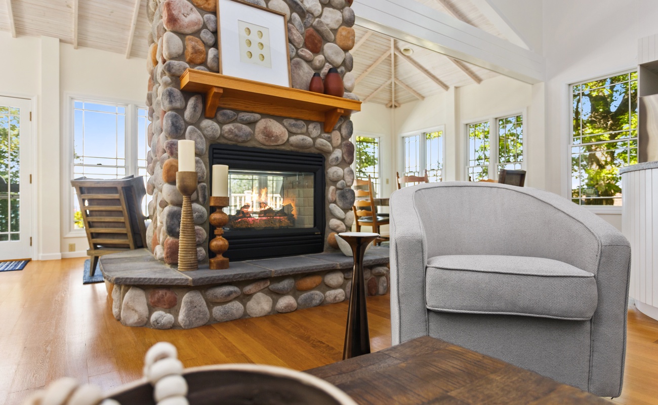 A stone and glass double sided gas fireplace provides cozy ambiance year-round.