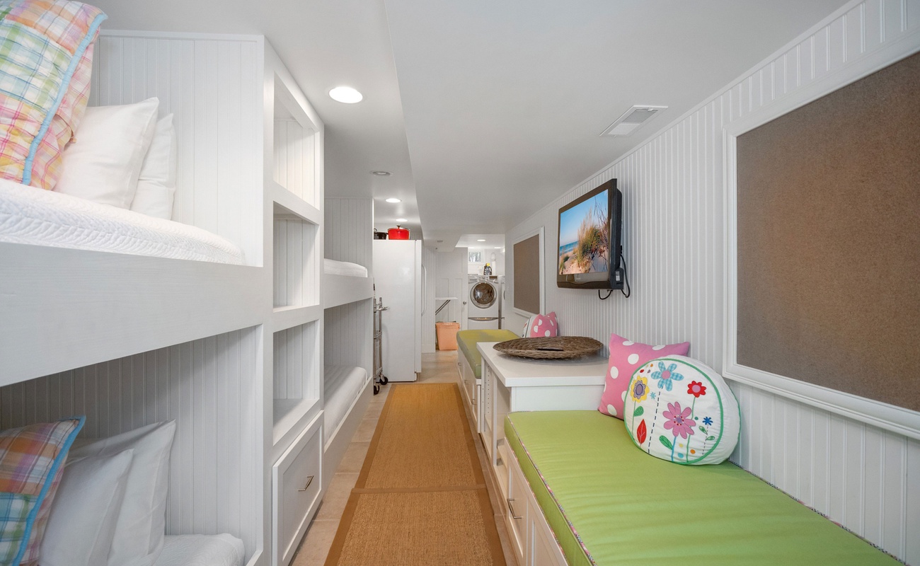 Two sets of bunk beds and a flat-screen TV on the lower level. Ooh-la-la!