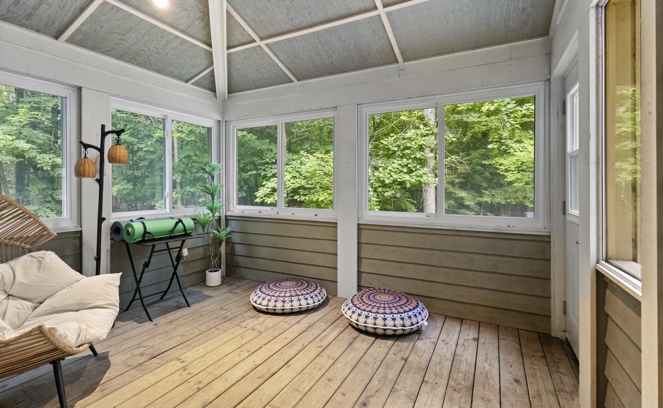 Find your zen in this serene forest-view sunroom.
