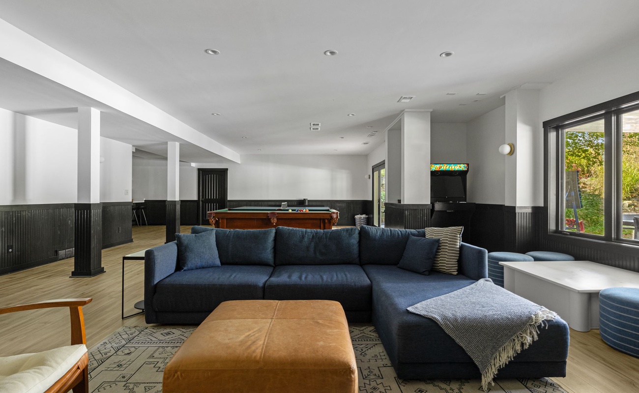 The ultimate chill zone: cozy seating, pool table, and arcade vibes.