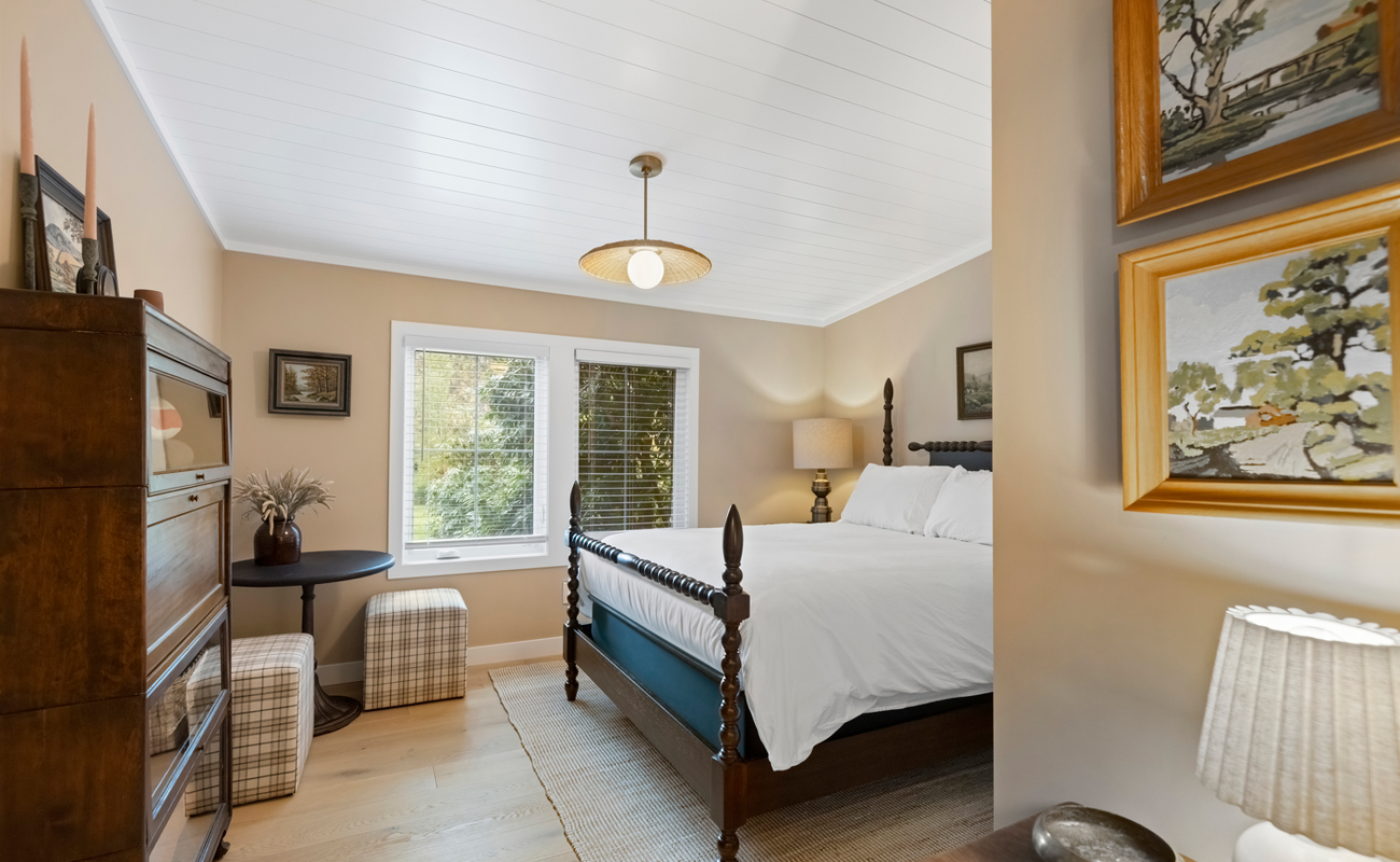 A bright bedroom blending comfort and classic design.