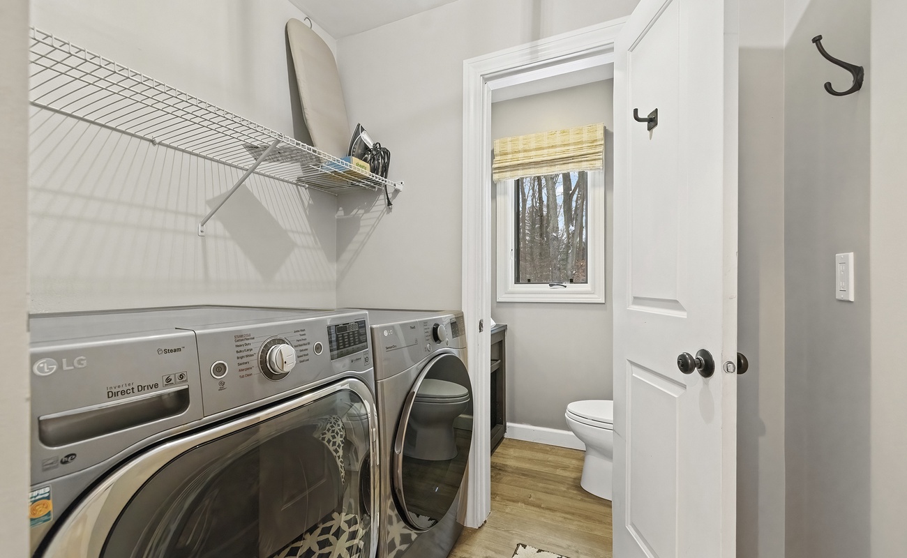 Our tidy laundry space has a bonus half bath for added convenience.