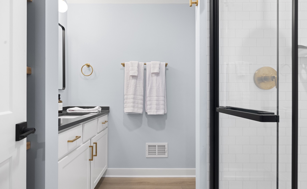 Enjoy a soothing shower in this bright and polished bathroom retreat.