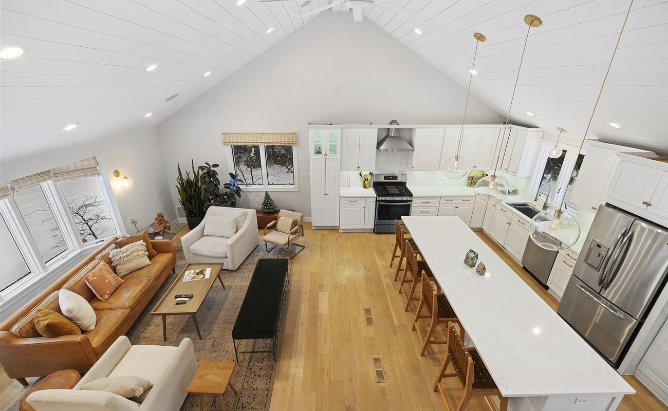 A sweeping view of the home’s warm, welcoming living and kitchen spaces.